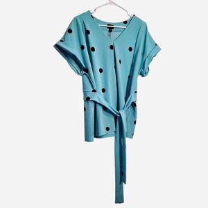 Size XL Worthington Black polka dot wrap top on a light blue background